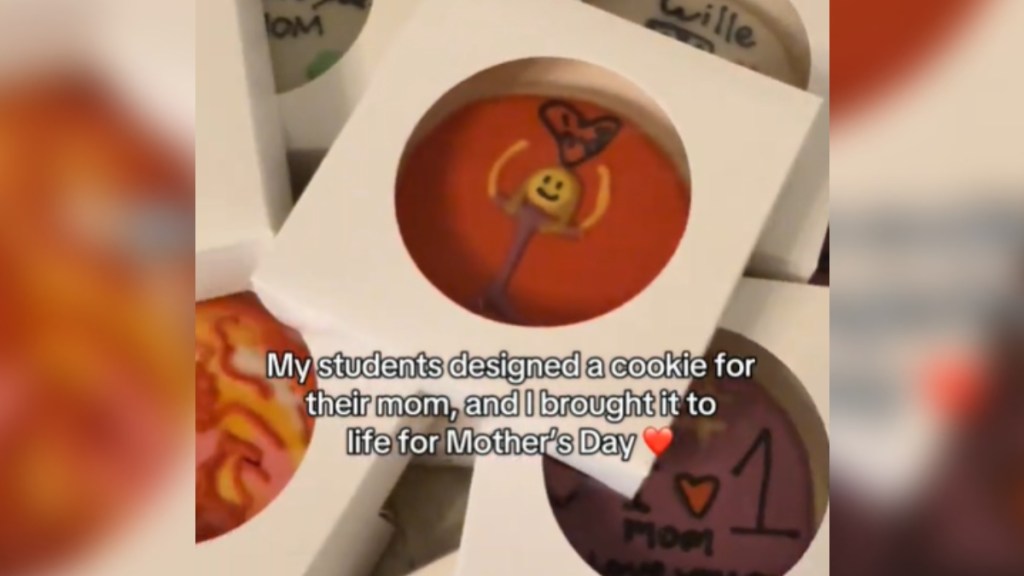 Cookies in small containers are stacked on top of each other, clearly designed by kids. Text on the image reads: "My students designed a cookie for their mom, and I brought it to life for Mother's Day"