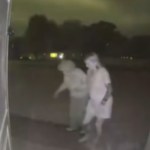 Front door camera shows a woman helping an elderly woman walk up to their home at night during a storm