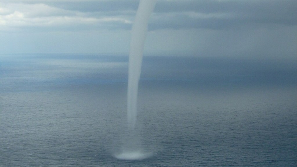 A waterspout moves over the water